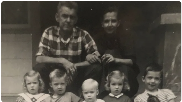 black and white photo of the Leonard family. A man and woman and five small children.